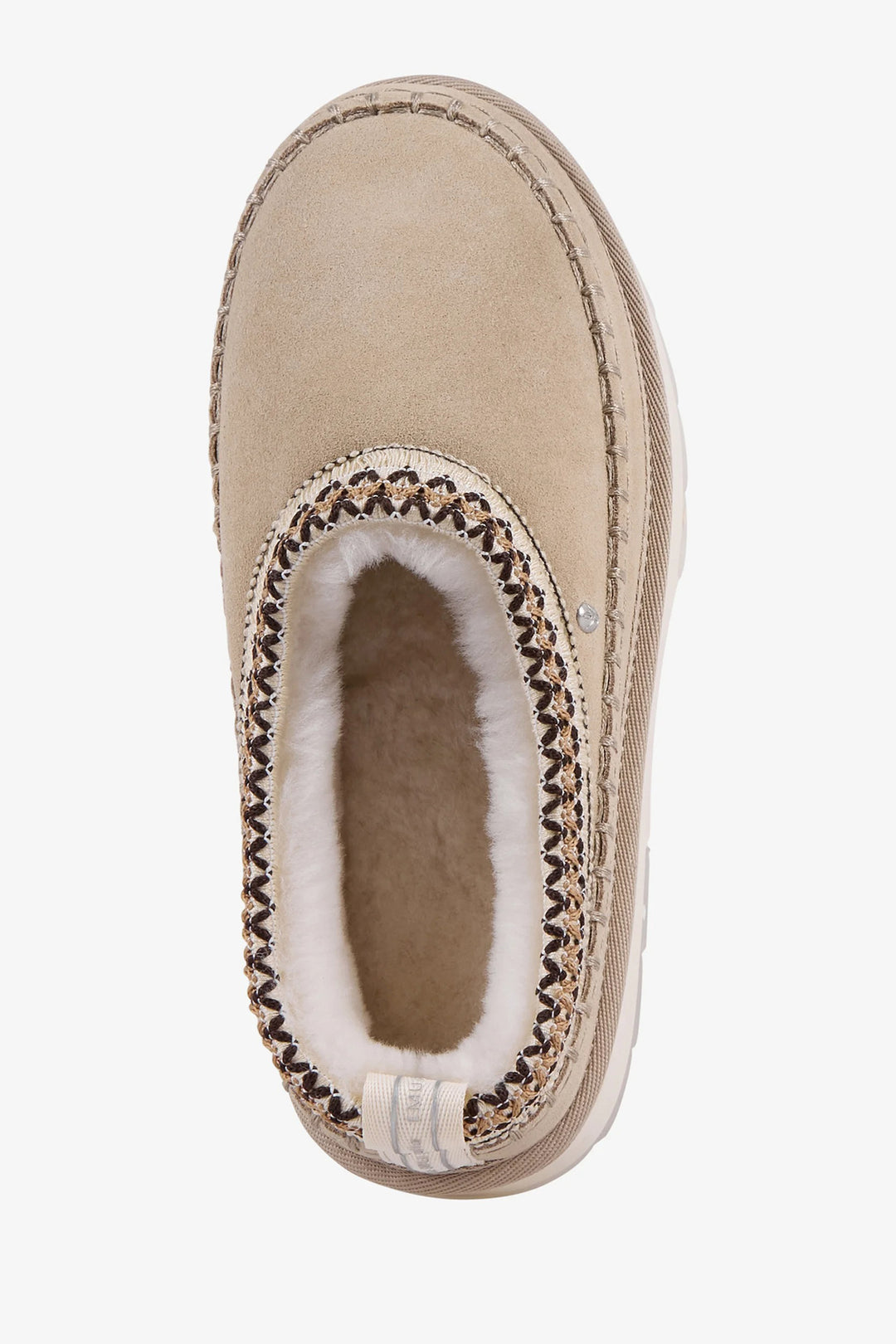 Beige slipper with brown trim and white fur lining on a light beige background