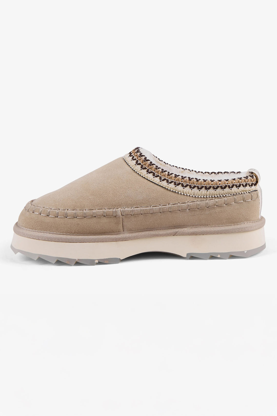 Beige slip-on shoe with textured trim on a white background