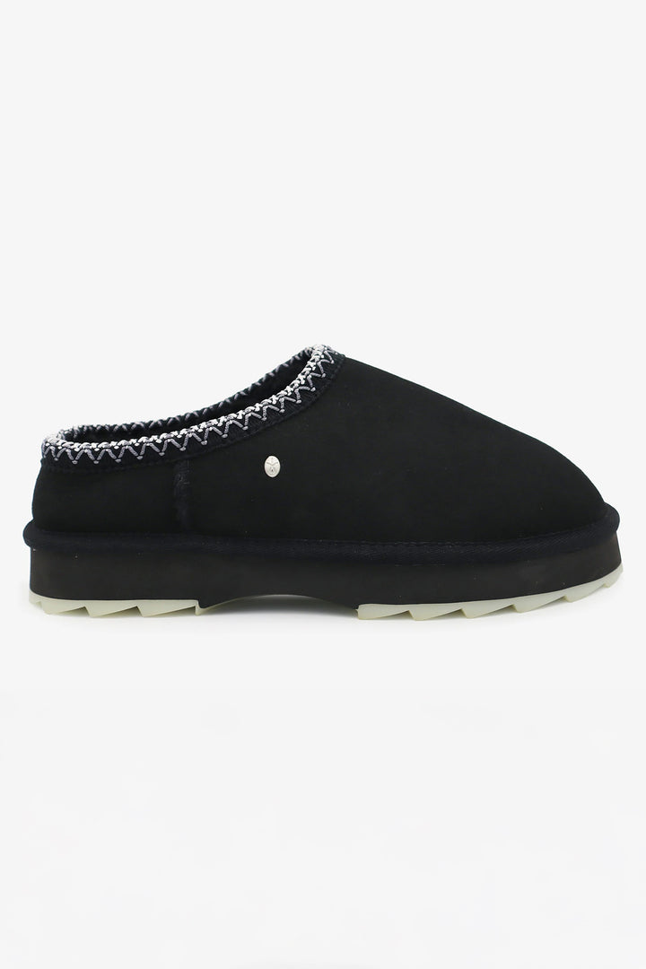 Black slipper with decorative trim on a white background