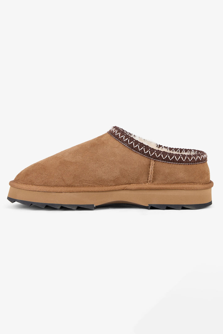 Tan slipper with patterned interior on a white background