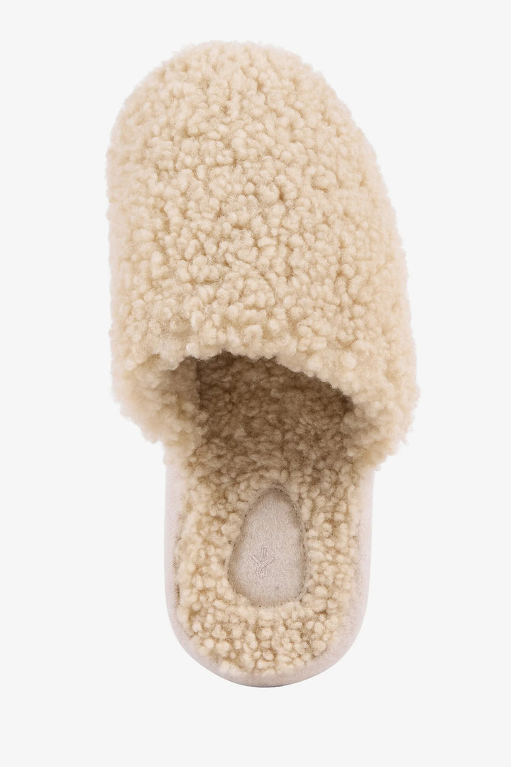 Beige slipper with fuzzy texture on a white background