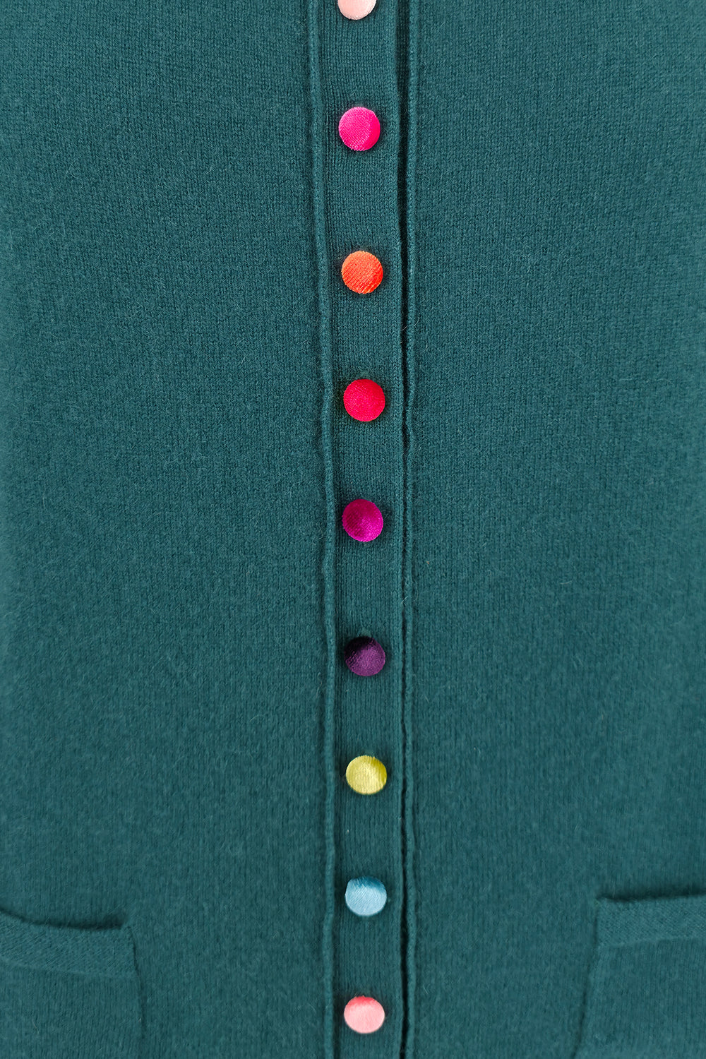 Close-up of a teal garment with colorful buttons