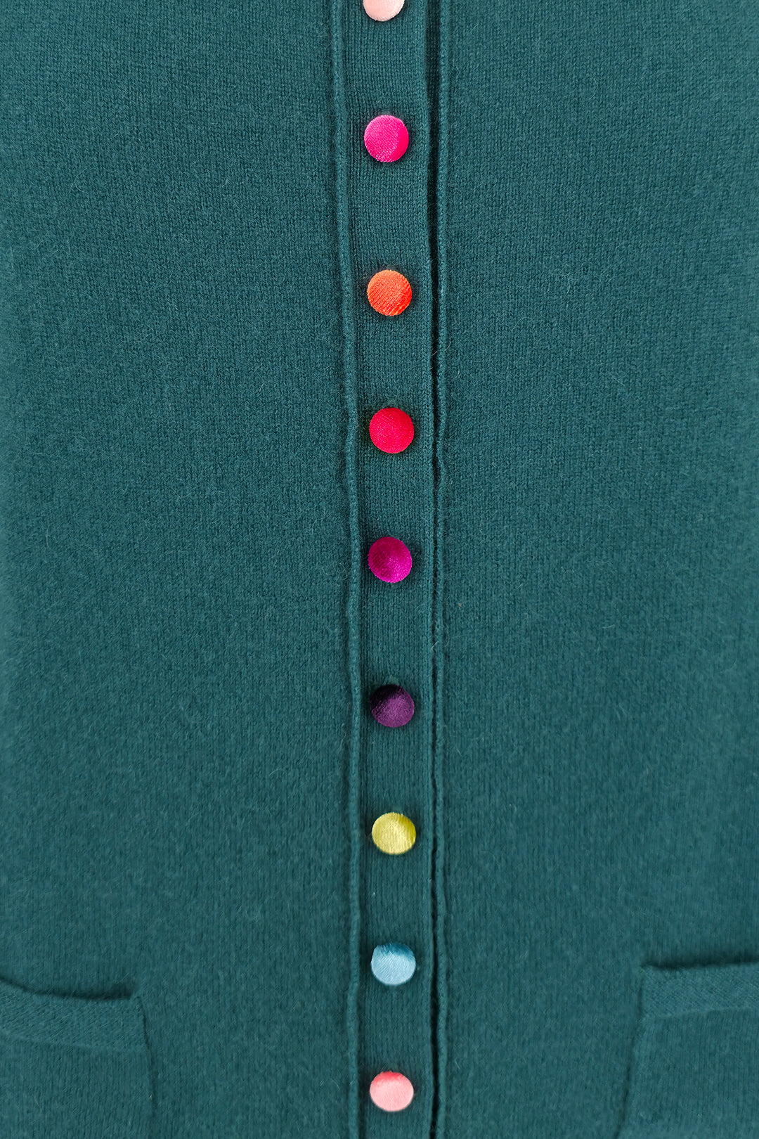 Close-up of a teal garment with colorful buttons