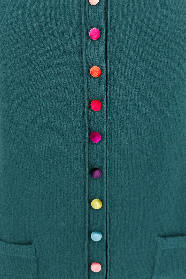 Close-up of a teal garment with colorful buttons