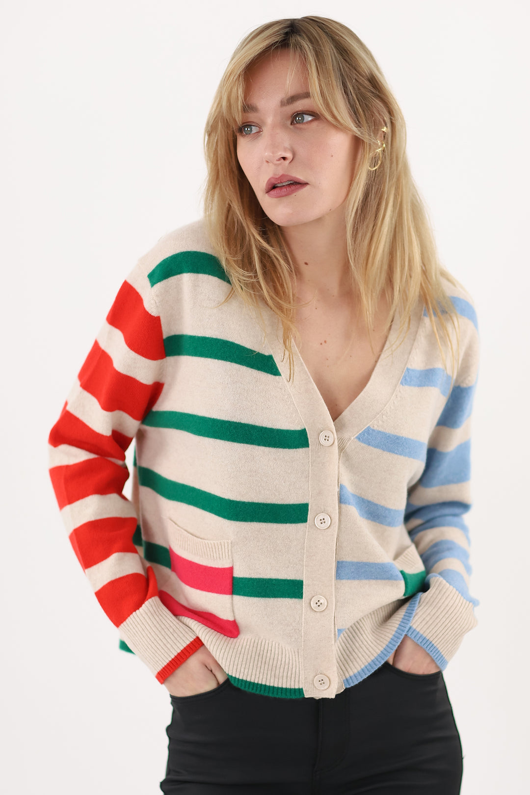 Woman wearing a colorful striped cardigan on a white background