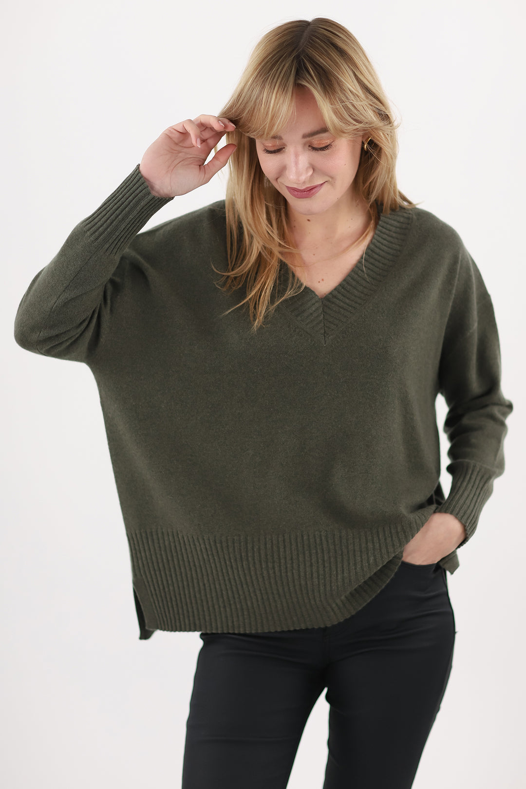 Woman wearing a green sweater on a white background