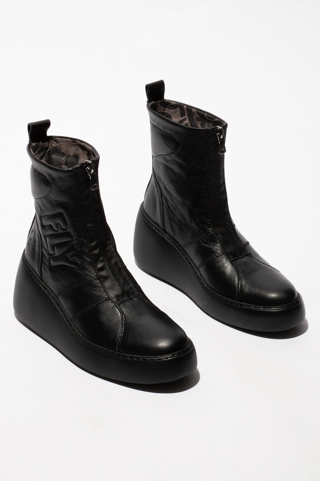 Pair of black leather boots on a white background