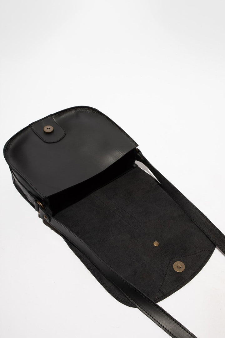 Black leather bag with a strap on a white background