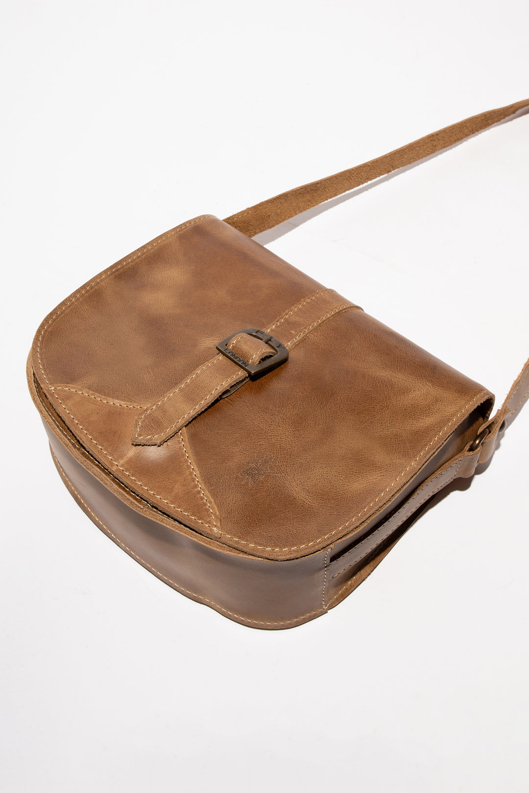 Brown leather bag with a strap on a white background