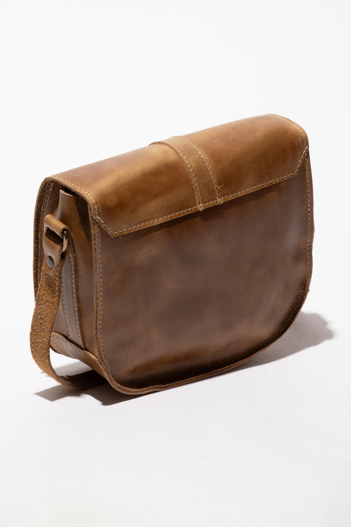 Brown leather satchel bag on a white background