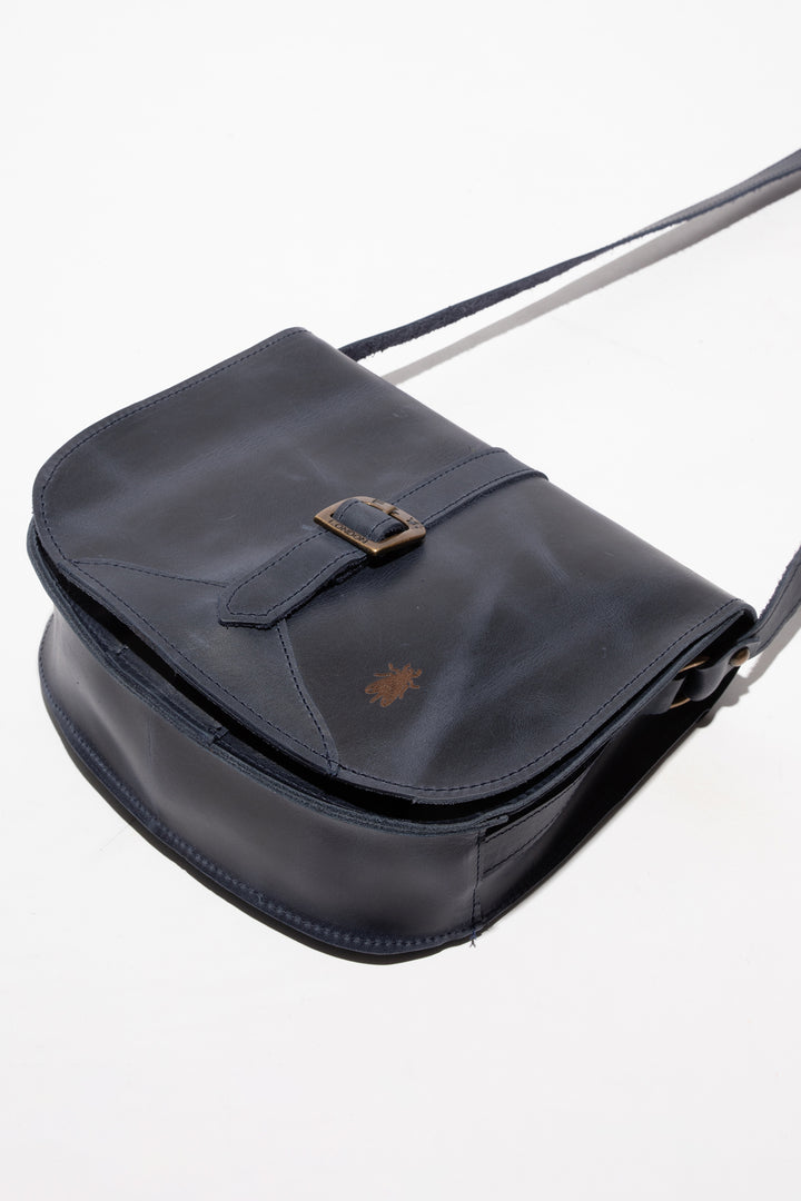 Black leather bag with a buckle on a white background