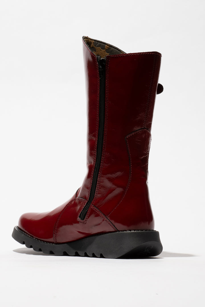 Red boot with a black zipper on a white background