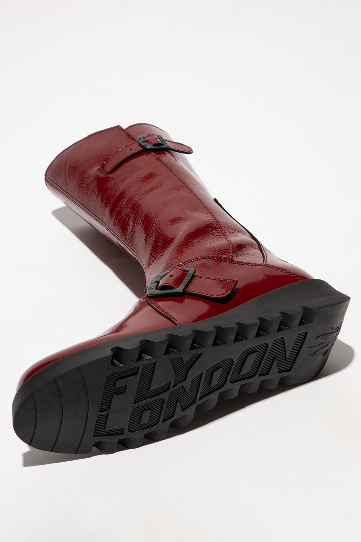 Red boot with black sole on a white background