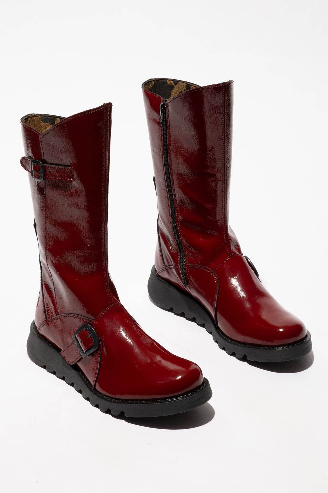 Pair of red leather boots on a white background