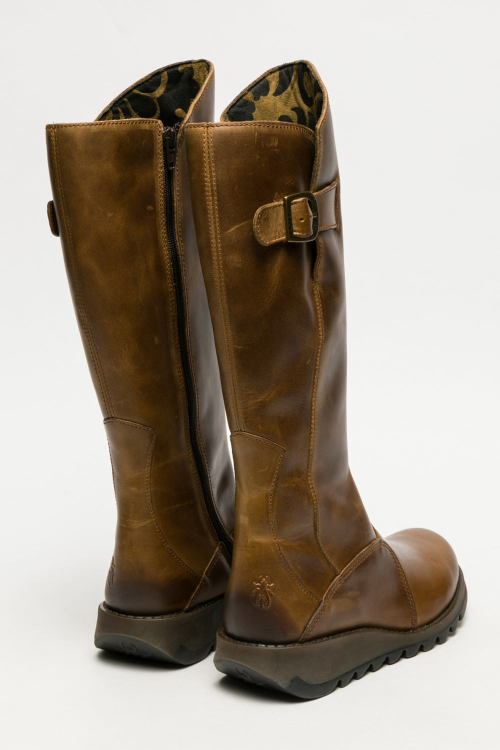 Pair of brown leather knee-high boots on a white background