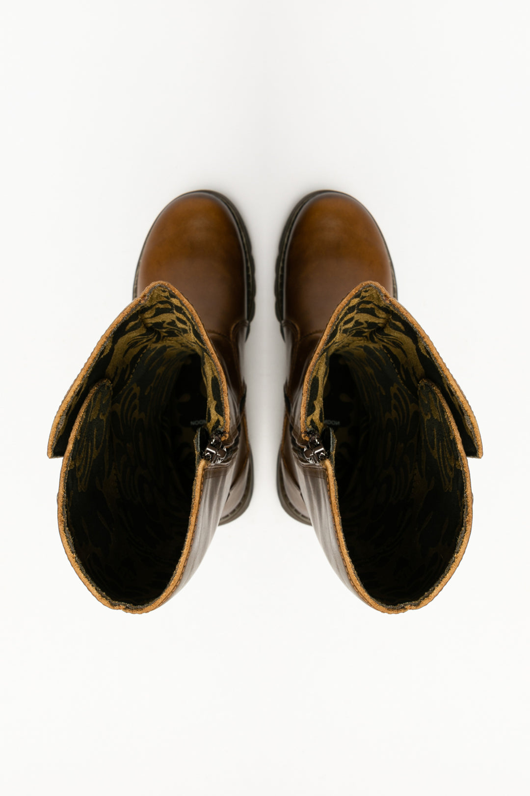 Pair of brown leather boots with decorative bows on a white background