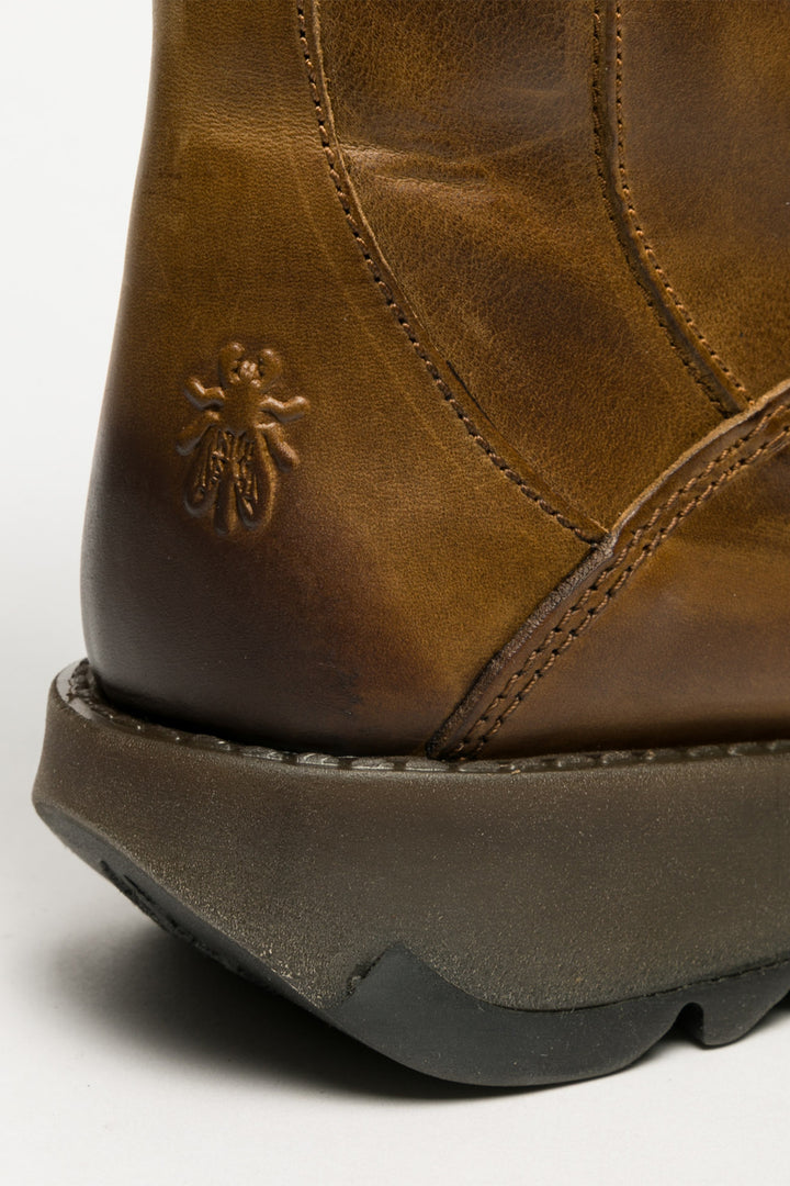 Close-up of a brown leather boot with a brand logo on a white background