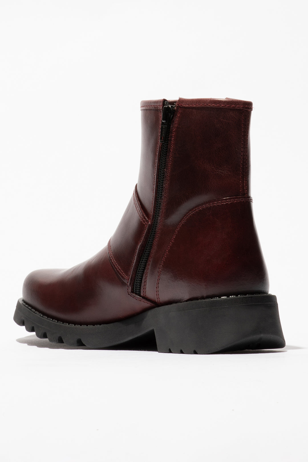 Brown leather boot with a black sole on a white background