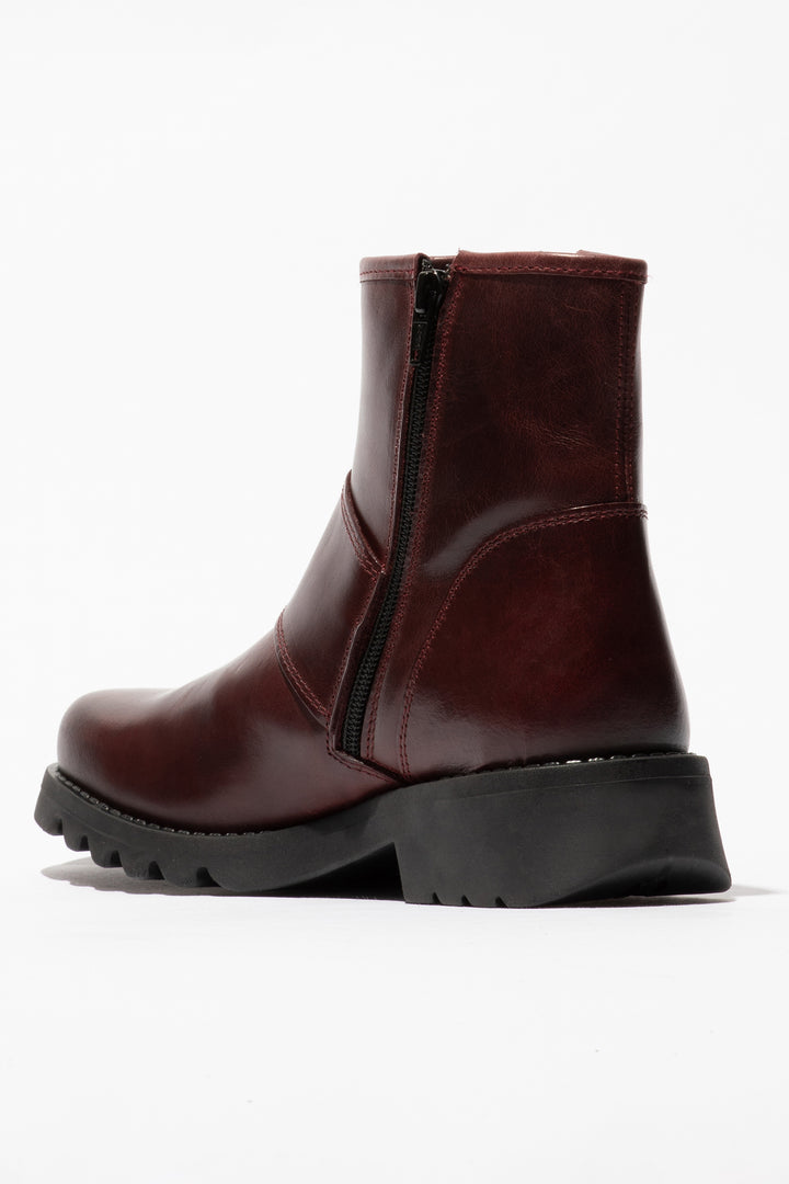 Brown leather boot with a black sole on a white background