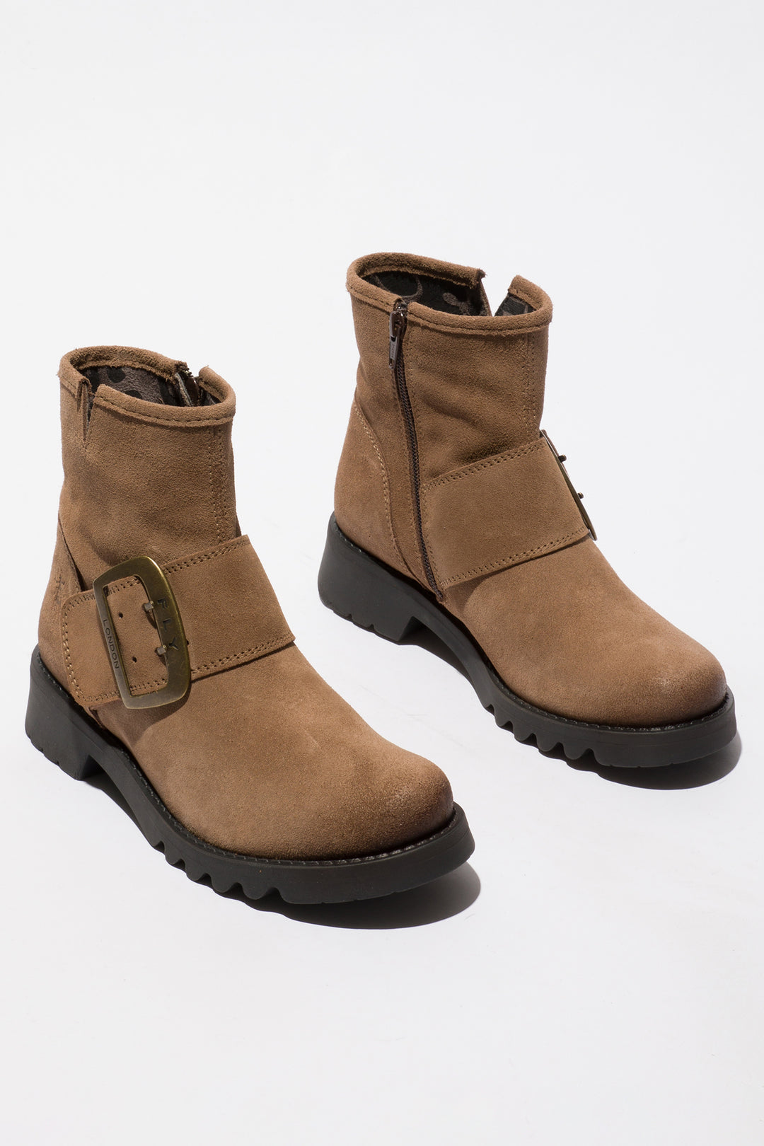 Pair of brown boots with a buckle on a white background