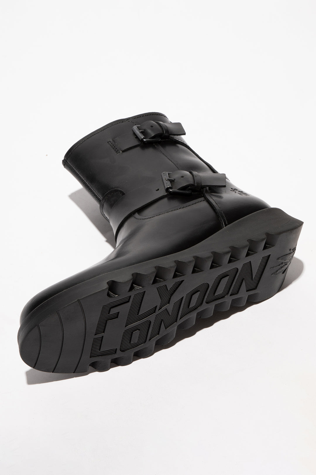 Black rubber boot with 'Fly London' branding on a white background