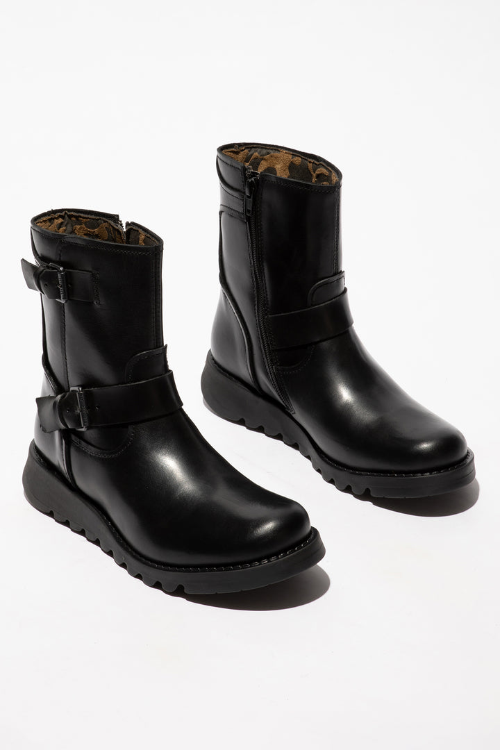 Pair of black leather boots with buckles on a white background
