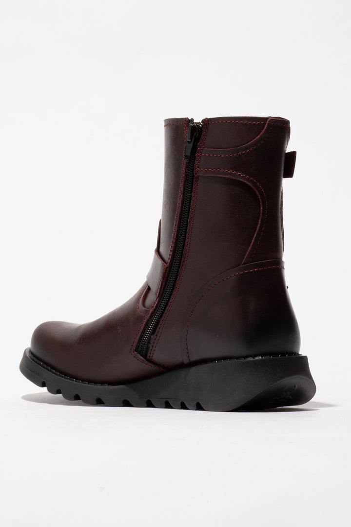 Brown ankle boot with a zipper on a white background