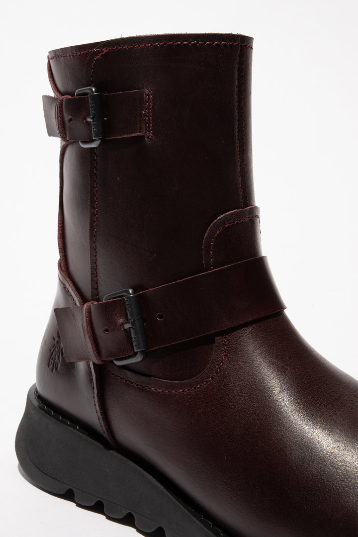 Brown leather boot with buckles on a white background