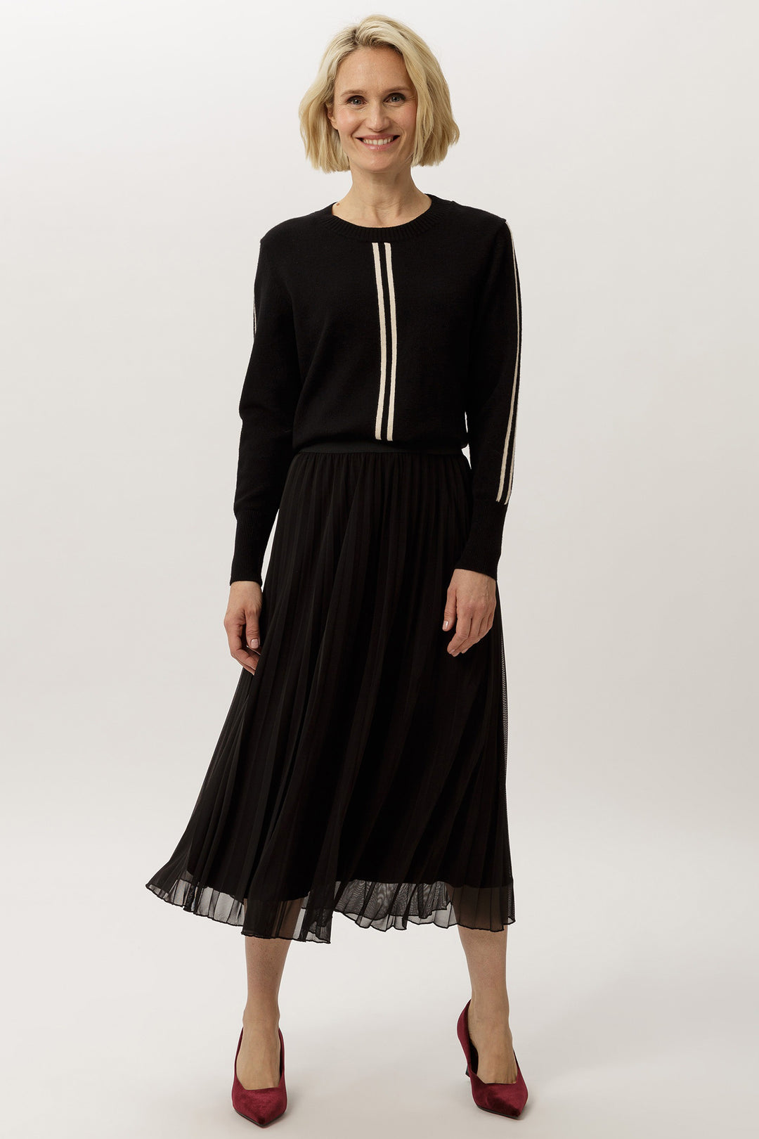 Woman wearing a black outfit with a white background