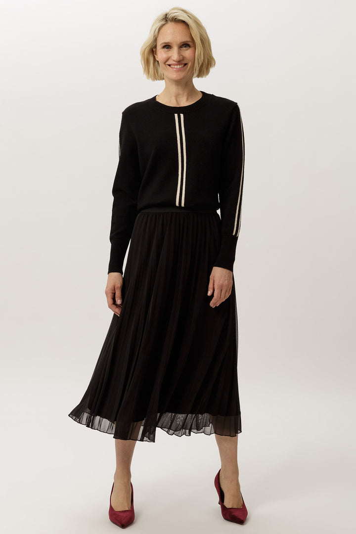Woman wearing a black outfit with a white background