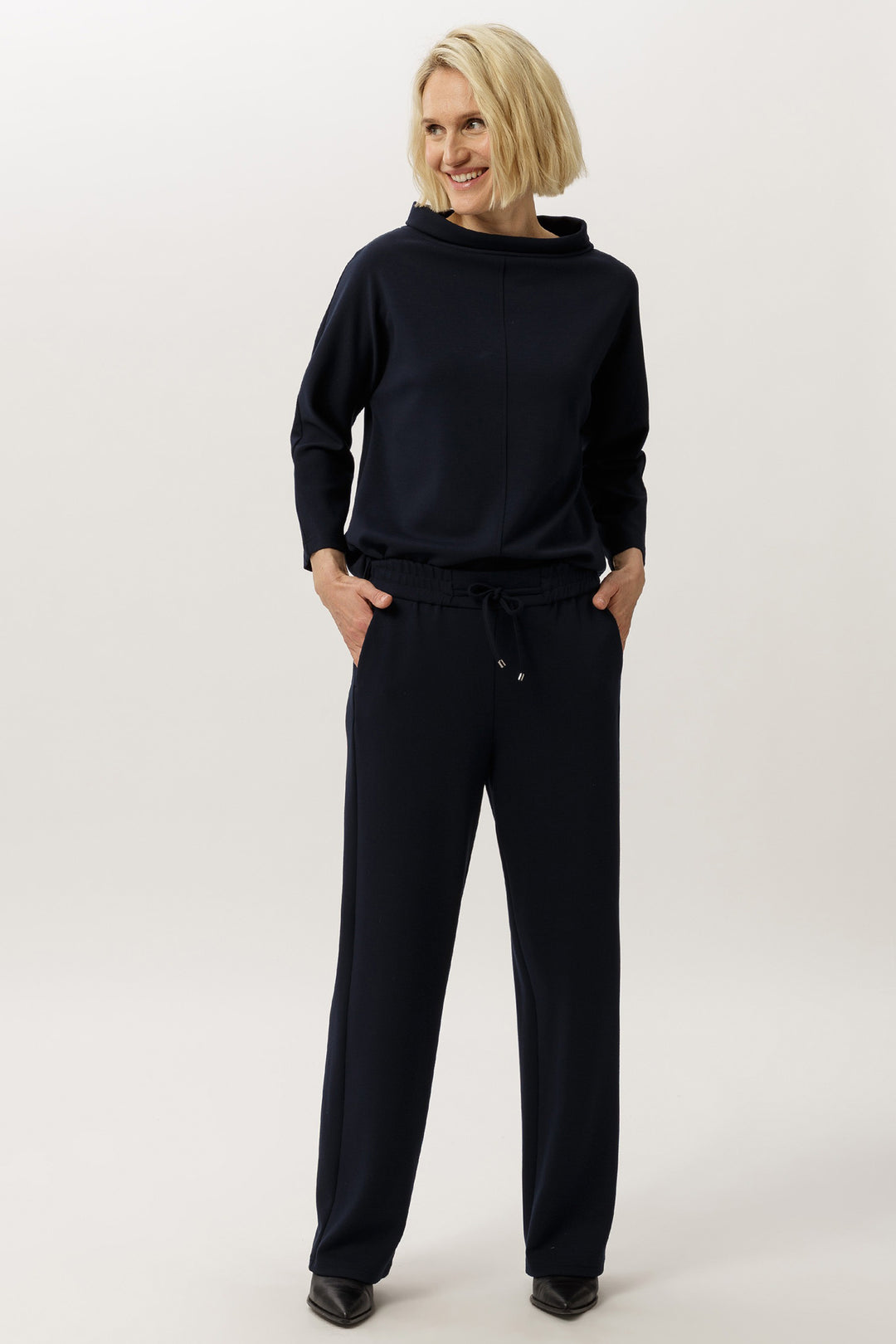 Person wearing a black outfit on a white background