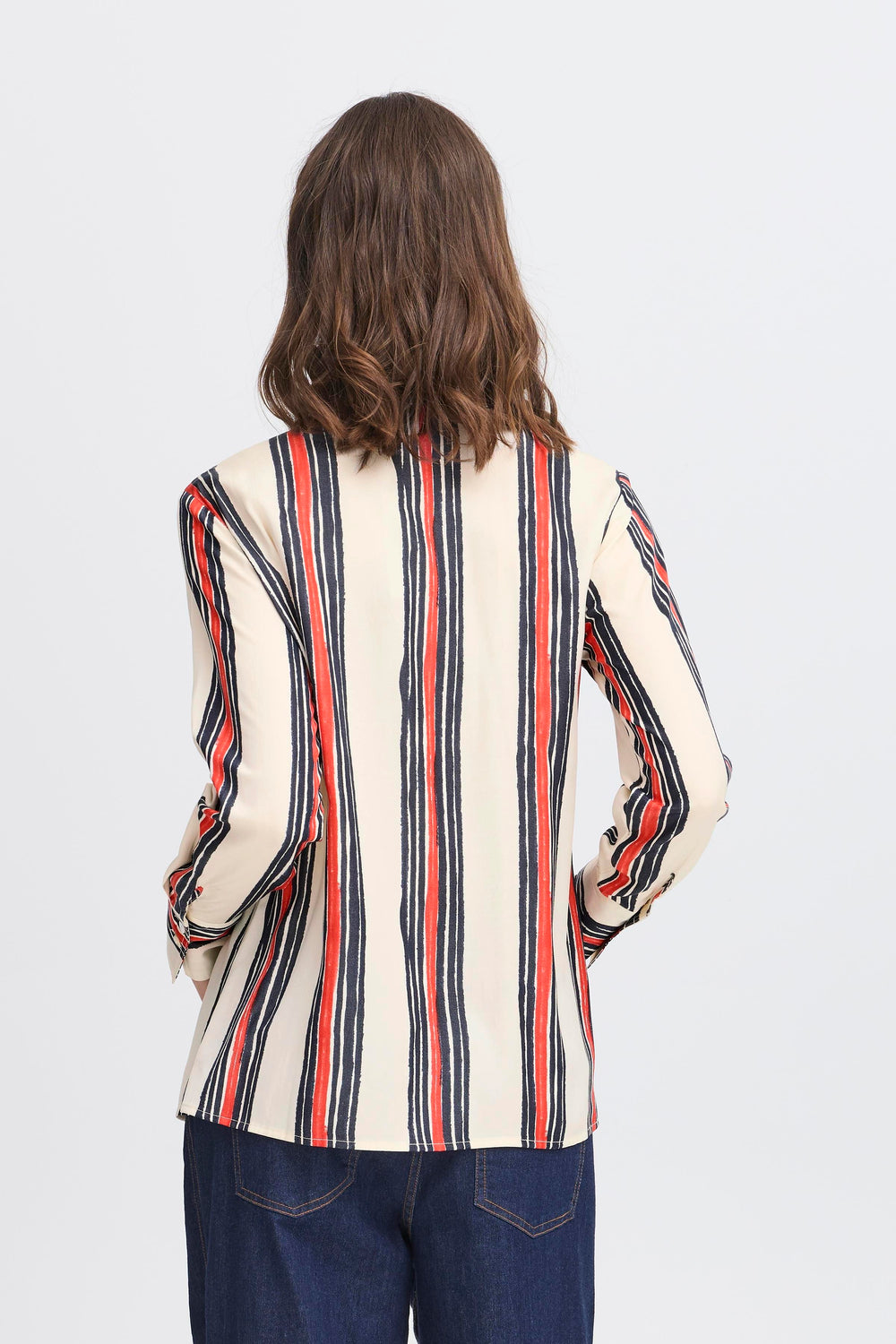 Person wearing a striped shirt with long sleeves on a white background