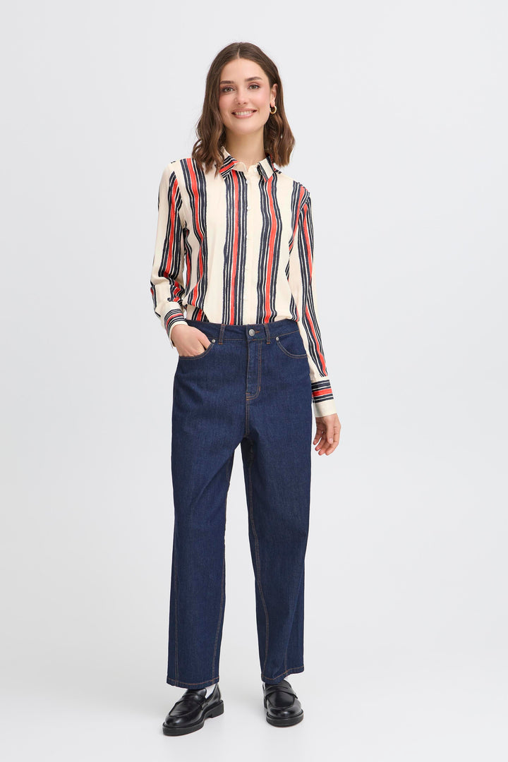 Woman wearing a striped shirt and blue jeans on a white background