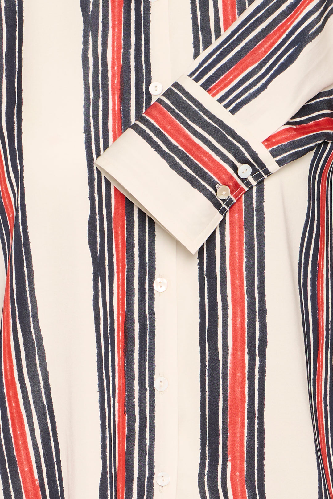 Close-up of a striped shirt with red, blue, and white vertical stripes.