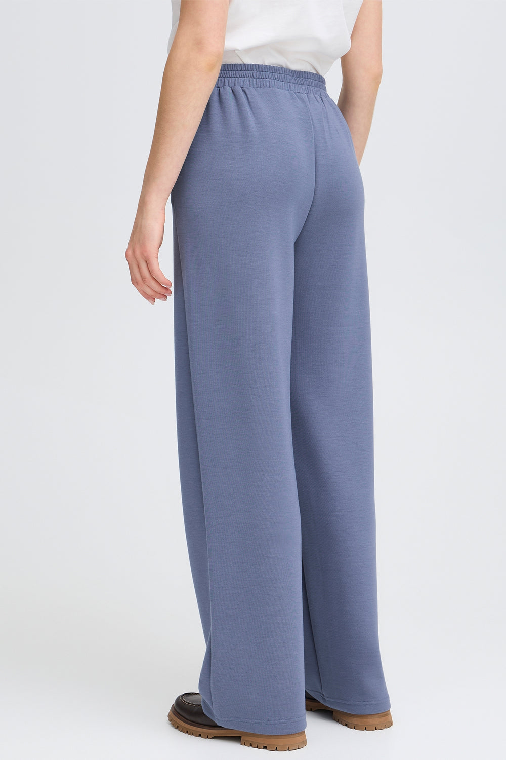 Person wearing blue pants on a white background