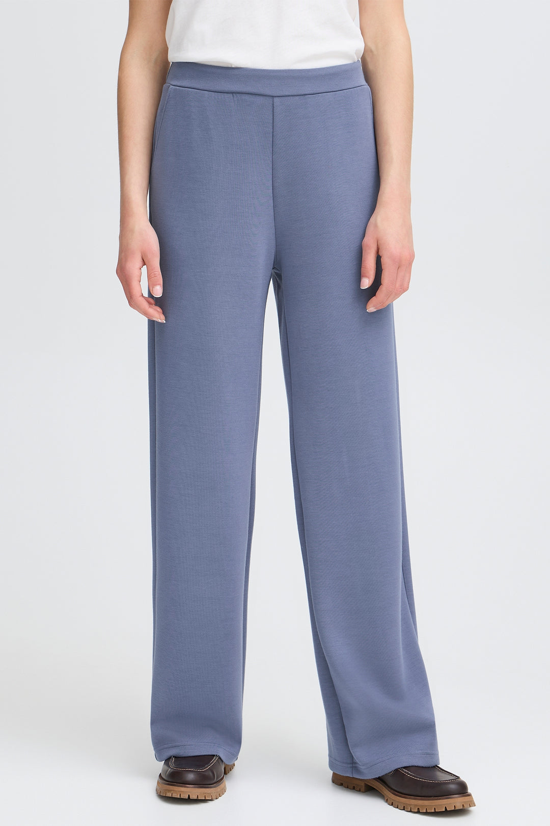Person wearing blue pants on a white background