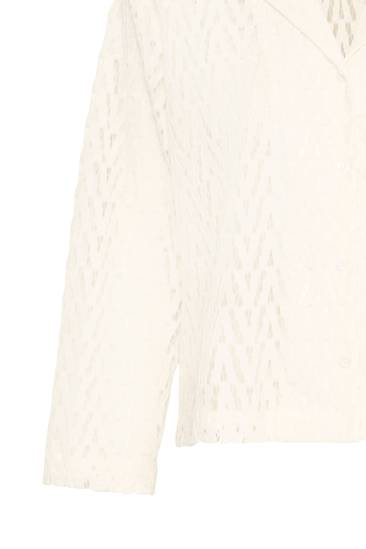 White cable knit sweater on a white background