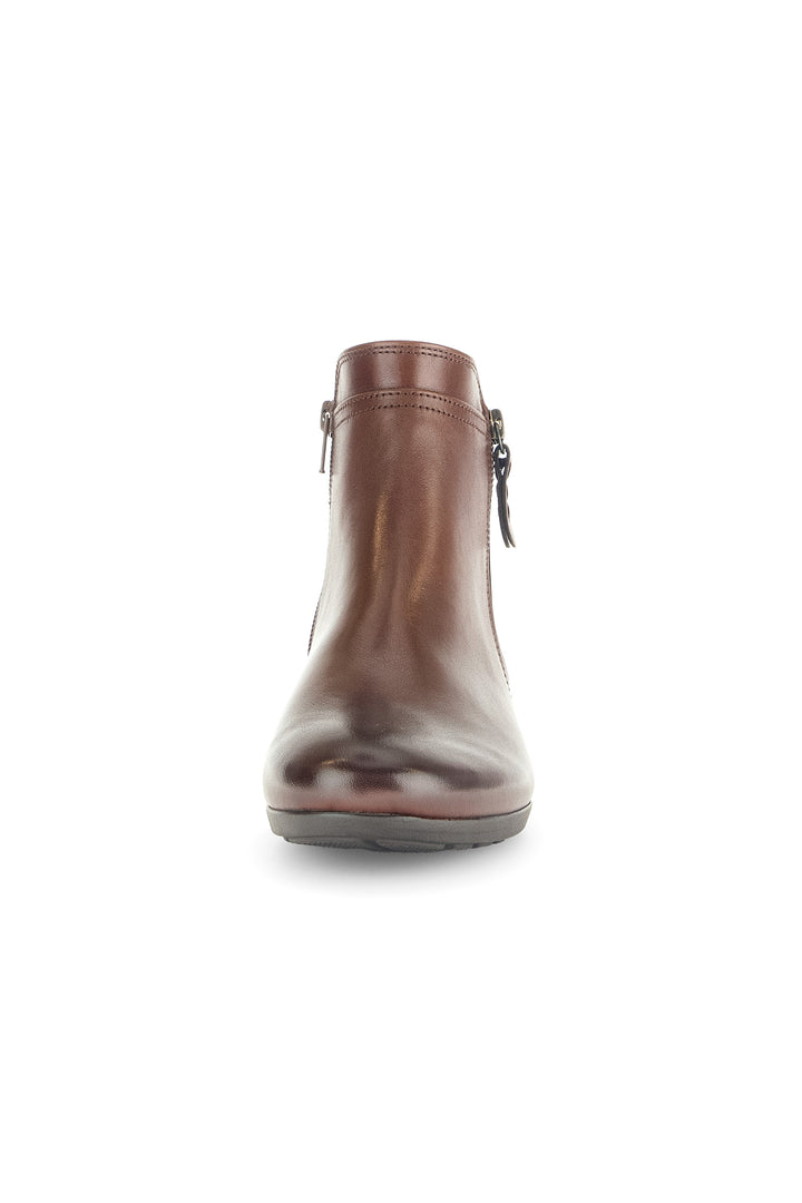 Brown leather boot with zippers on a white background
