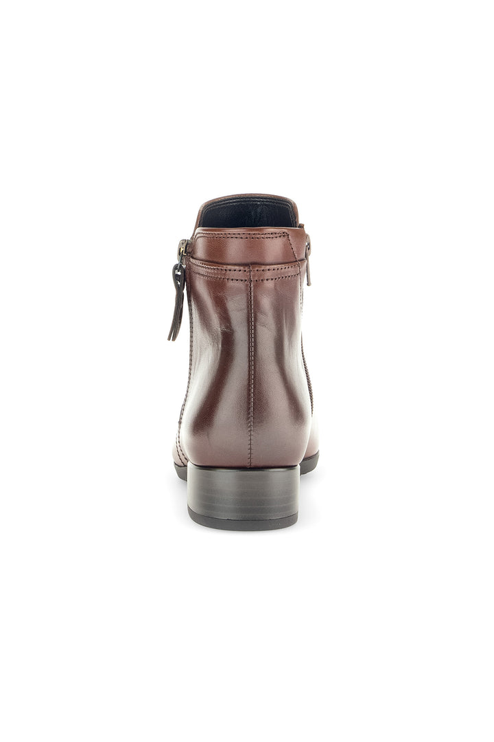 Brown leather boot with a zipper on a white background