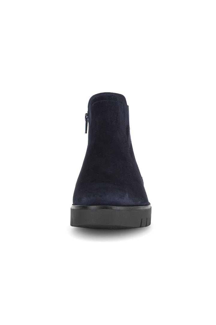 Navy blue suede ankle boot on a white background
