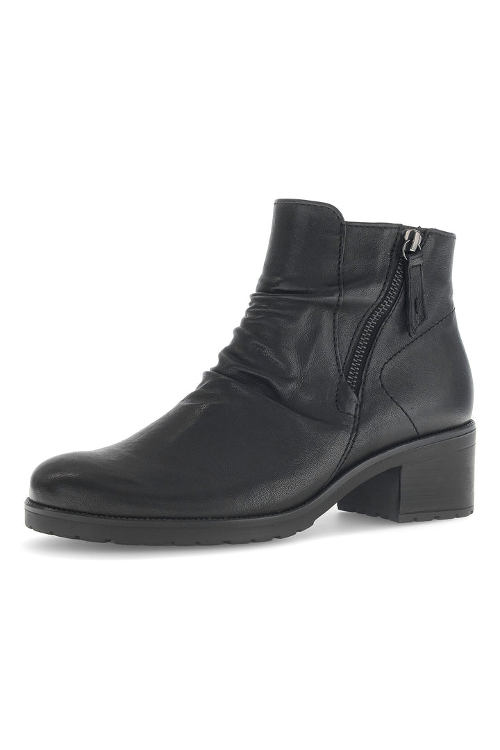 Black leather ankle boot with a zipper on a white background