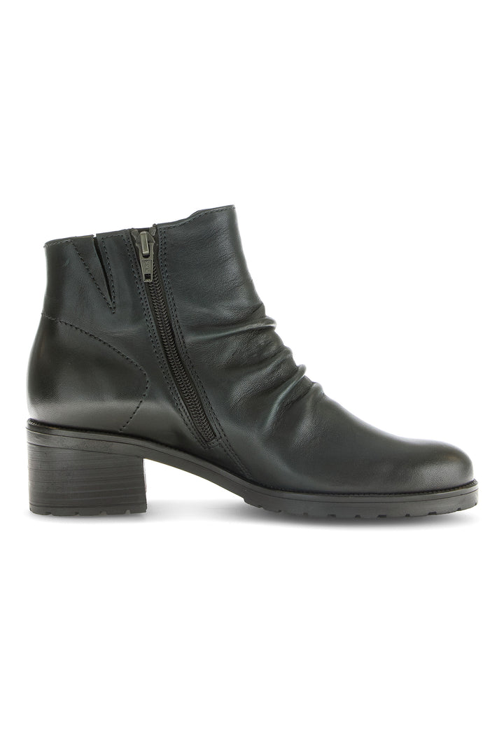 Black ankle boot with zipper on a white background