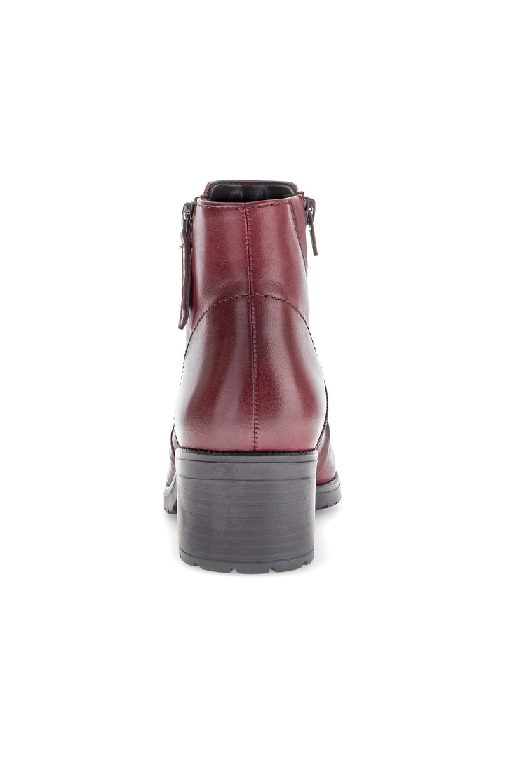 Red leather ankle boot on a white background
