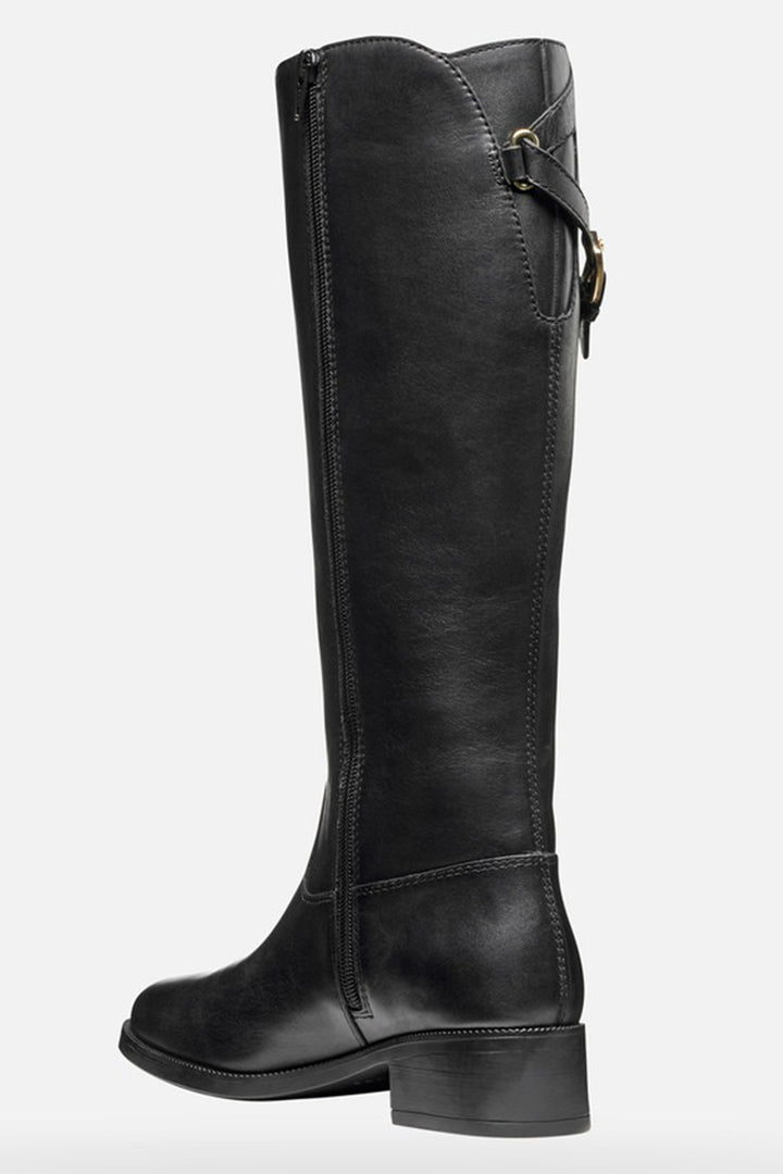 Black knee-high boot with a strap on a white background