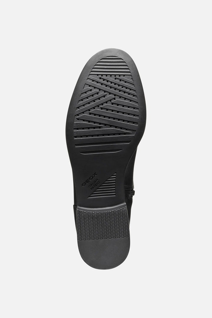 Black shoe sole with tread pattern on a white background