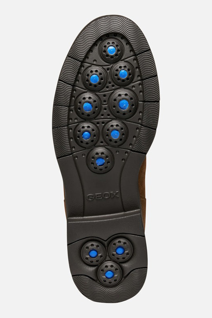 Close-up of a shoe sole with blue accents on a light gray background