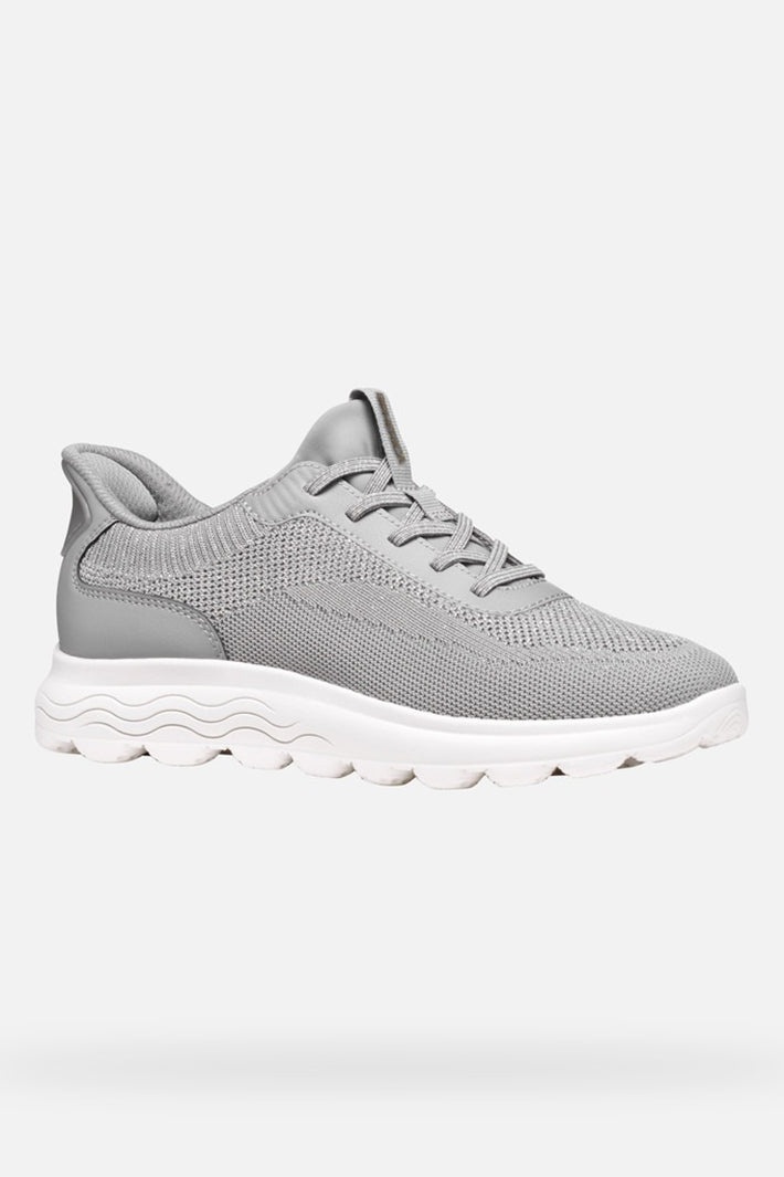 Gray sneaker with white sole on a light gray background
