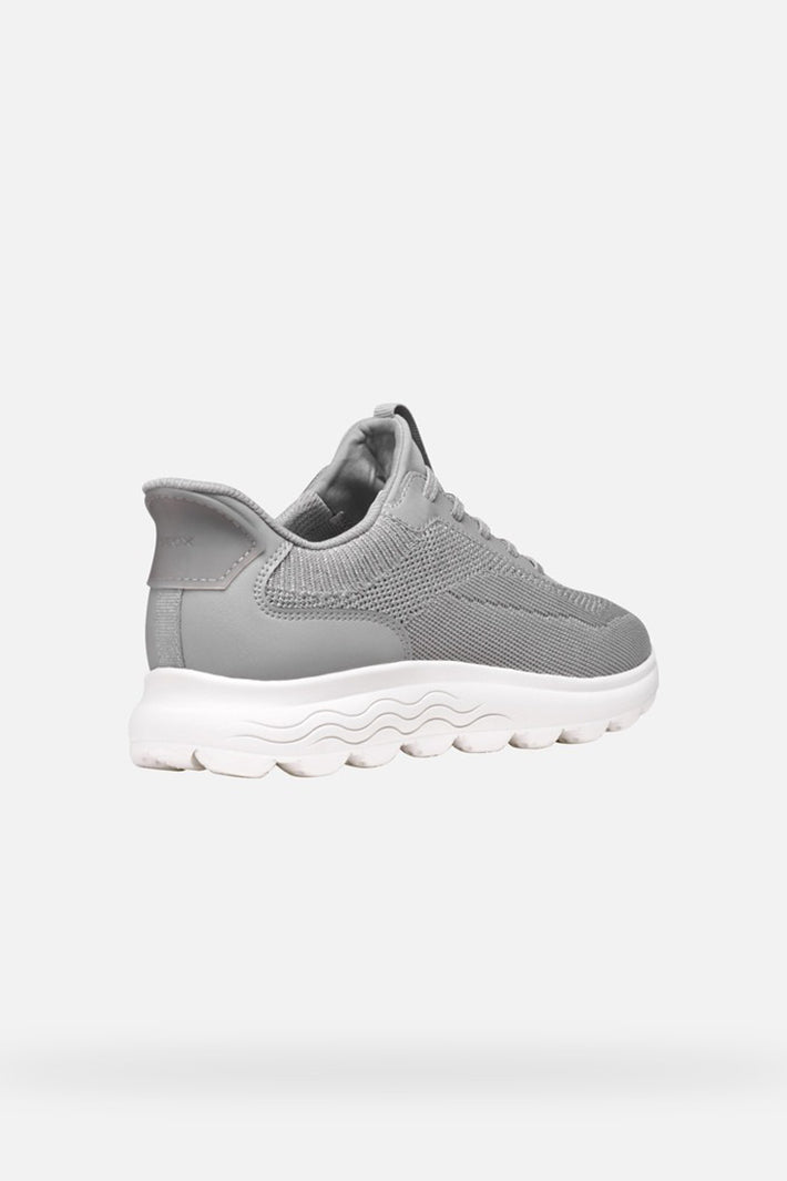 Gray sneaker with white sole on a light gray background