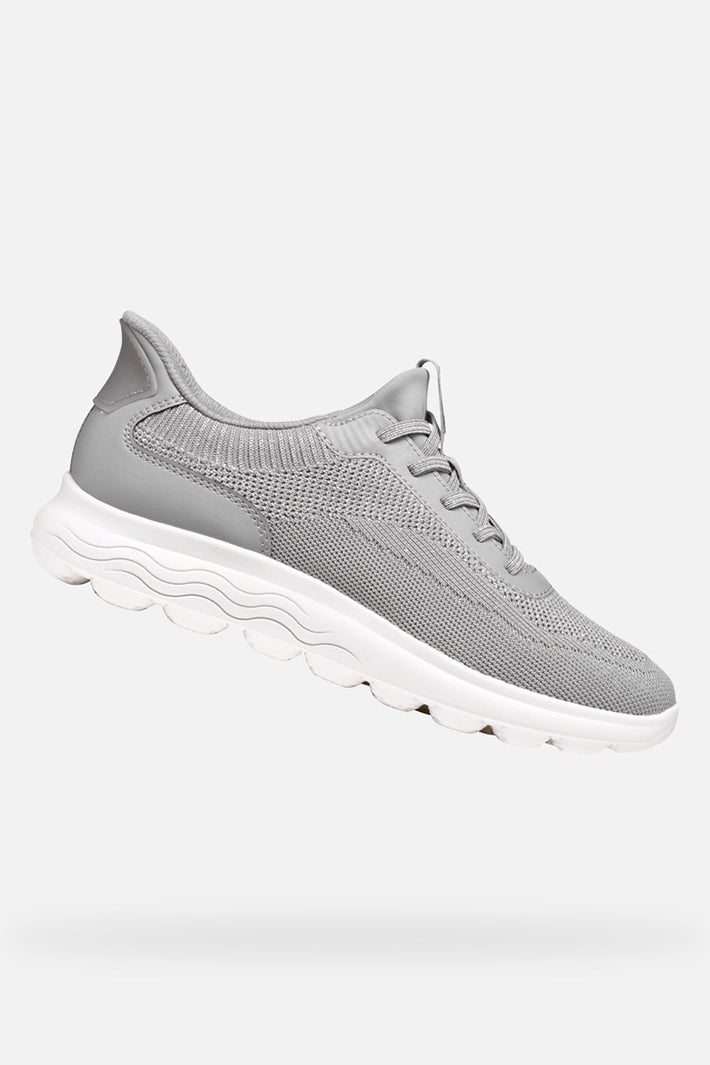 Gray sneakers with white soles on a light gray background