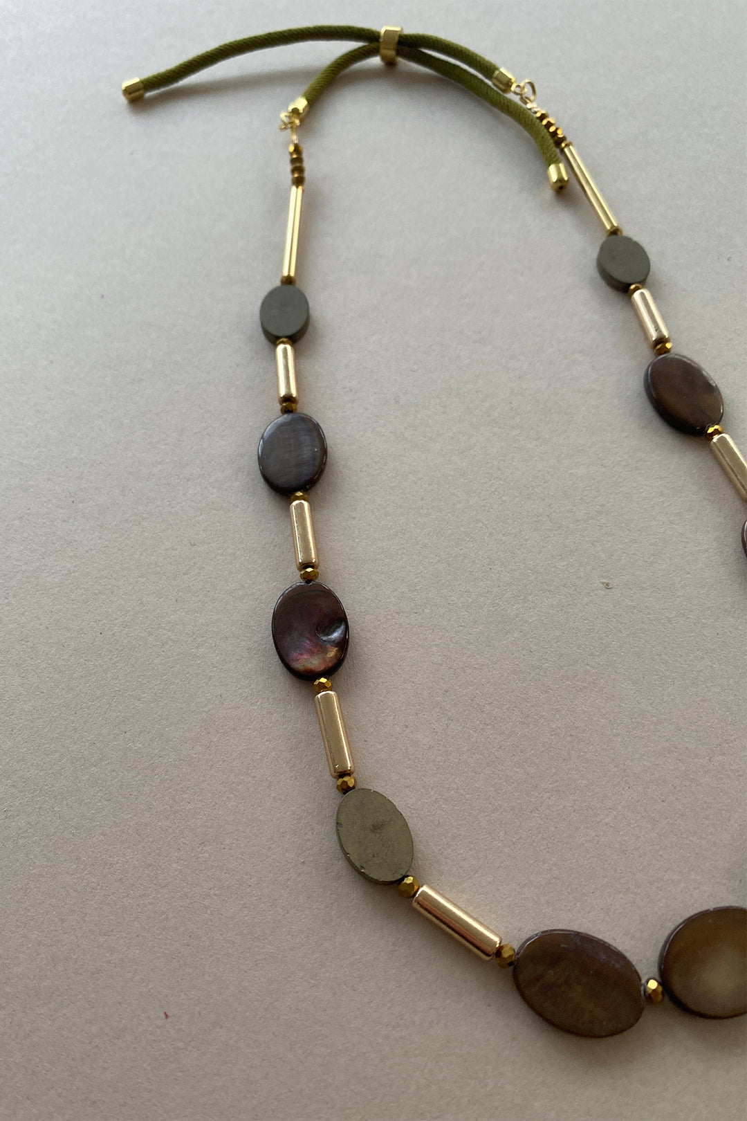 Gist Jewellery Brown Shell and Hematite Necklace BDL09, laid flat, angled